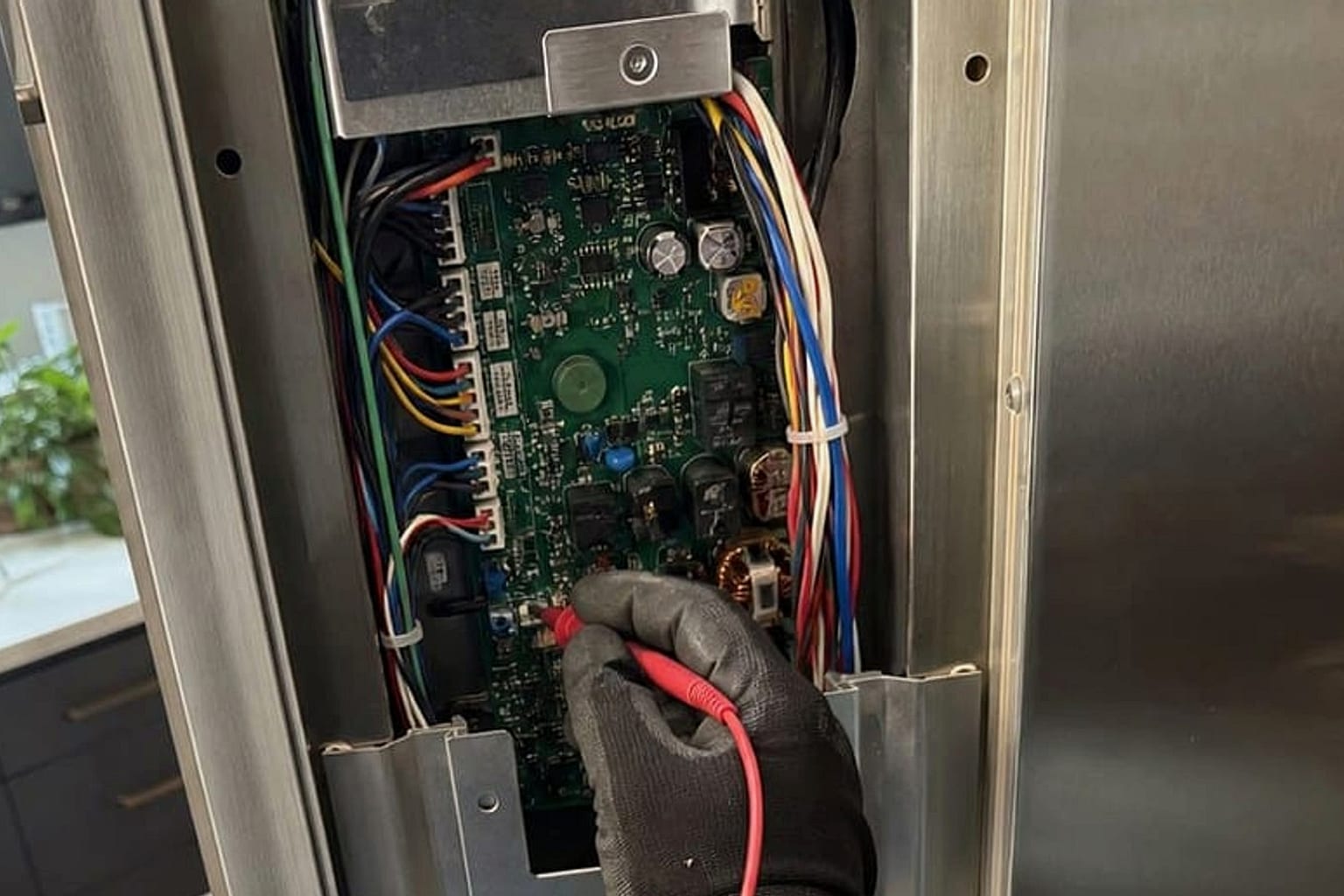 Technician testing the evaporator fan of a Sub-Zero 550 built-in refrigerator in Fremont